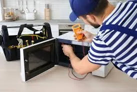 A man is repairing microwave oven